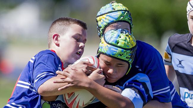 Day One of King of the Country rugby tournament at James Overell Park, Southport. Maroochydore Swans U14s' Andy Bailey in action against USQ Saints U14s (blue white small stripes). Picture: Jerad Williams