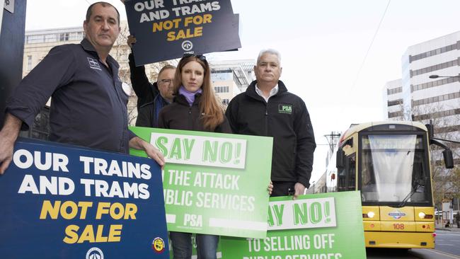 Branch secretary Darren Phillips, Natasha Brown and Nev Kitchin from the Public Service Association at the North Tce tram stop in front of the train station. Picture: Emma Brasier