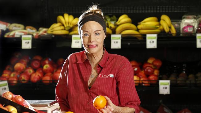 Burns survivor Carol Mayer arranges the fruit and vegetables at Holloways Beach Spar Express PICTURE: ANNA ROGERS