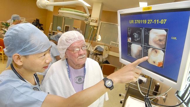 Dr Kwun Fong, left, views a lung cancer screening image at Prince Charles Hospital in Brisbane.