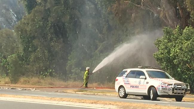 A firefighter battles a fire at Seaworld Drive on The Spit.