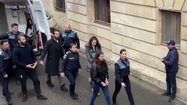 Andrew Tate flashes hand symbol as he arrives in court