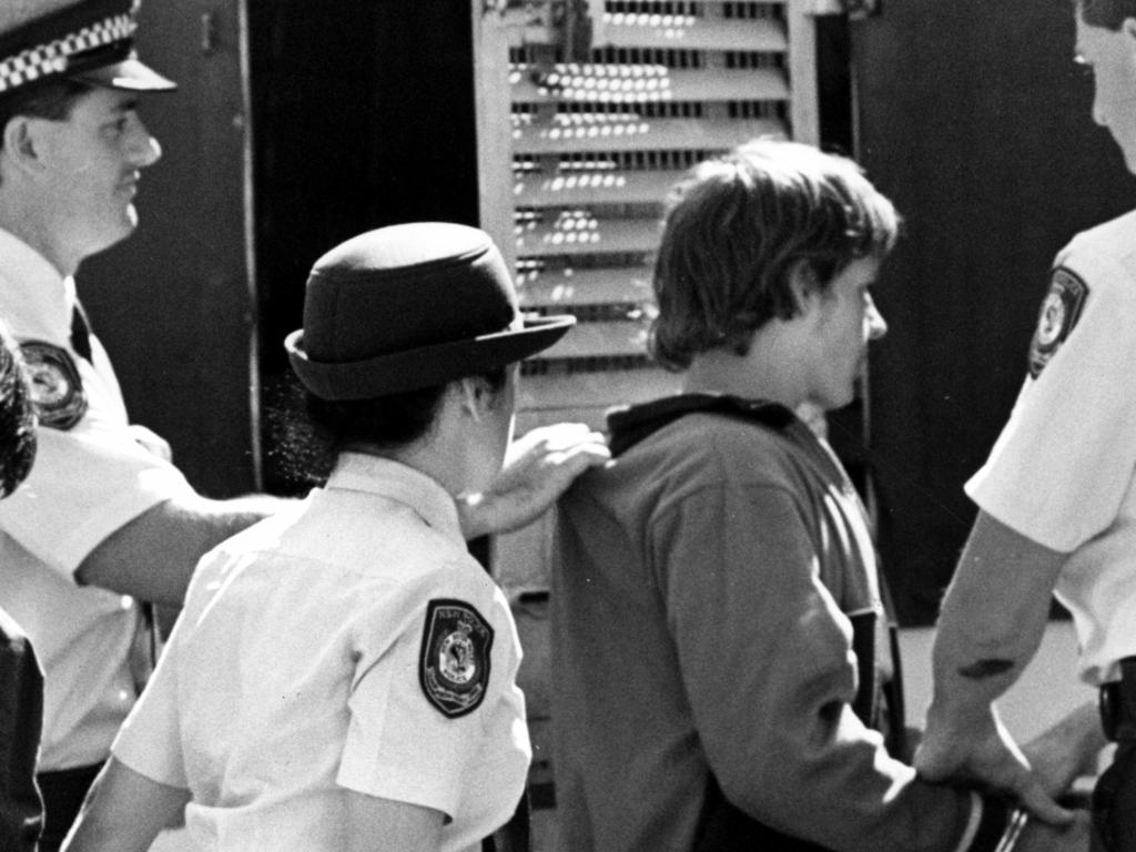 Wayne Wilmot escorted by police at Campbelltown Court on September 12, 1988. Picture: Uwe Kuessner