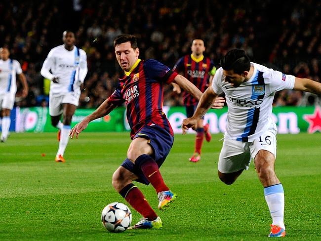 Lionel Messi of Barcelona is challenged by Sergio Aguero of Manchester City. Picture: David Ramos