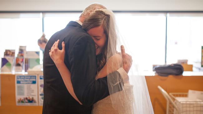 Sarah Foster embraces her father Eric before he walker her down the aisle at St Vincent’s Hospital Melbourne. Picture: Befekir Kebede