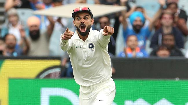 Virat Kohli celebrates after Jasprit Bumrah takes the wicket of Pat Cummins. Picture: AAP