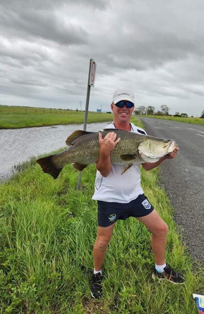 Proserpine local Kent Rasmussen shared a photo of himself with a one-metre barra he hooked in floodwaters about 10 minutes south of home. Picture: Contributed