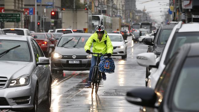 A cyclist navigates Sydney Rd. Picture: David Caird