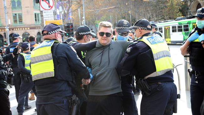 Police detain a man during a protest at Flinders Street Station in Melbourne on Saturday. Picture: Rebecca Michael