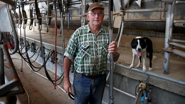 Dairy farmer Peter Enever with dog Jessie on his dairy farm that has been unused for two years. Picture: Toby Zerna