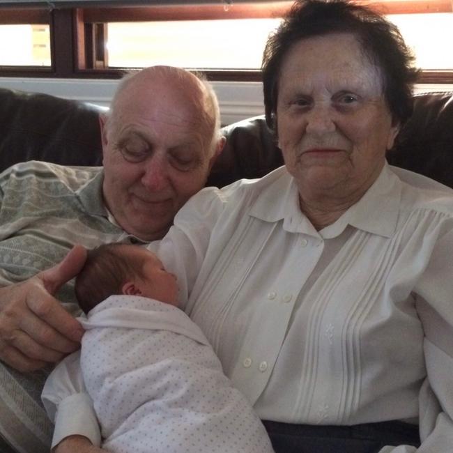 Mary Lillington with her grandchild and husband Peter