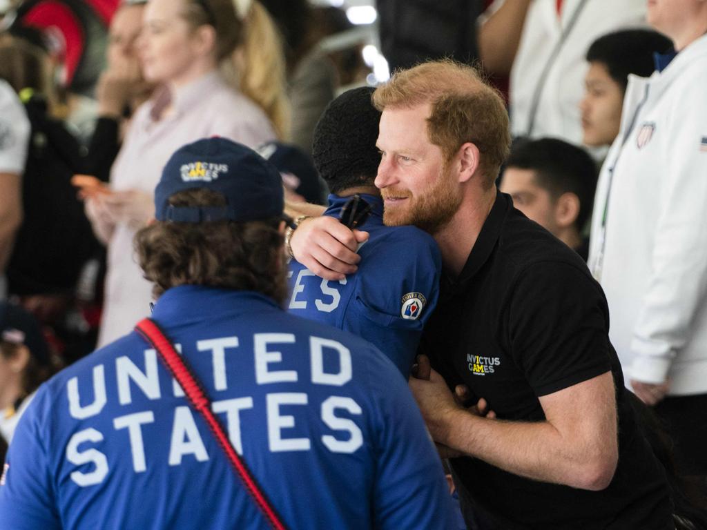 Britain's Duke of Sussex Prince Harry (C) embraces athletes during the archery event at the fifth edition of The Invictus Games in The Hague. Picture: AFP / Netherlands OUT