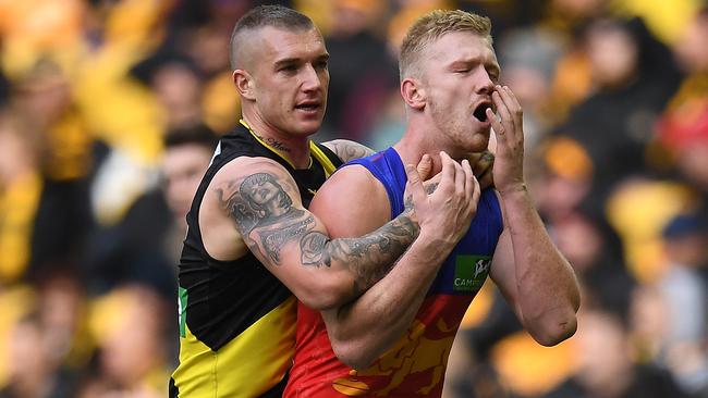 Dustin Martin tangles with Brisbane tagger Nick Robertson.