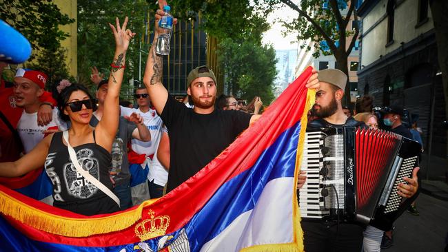 Djokovic supporters dance and celebrate outside the offices of his legal team in Melbourne on Monday. Picture: AFP