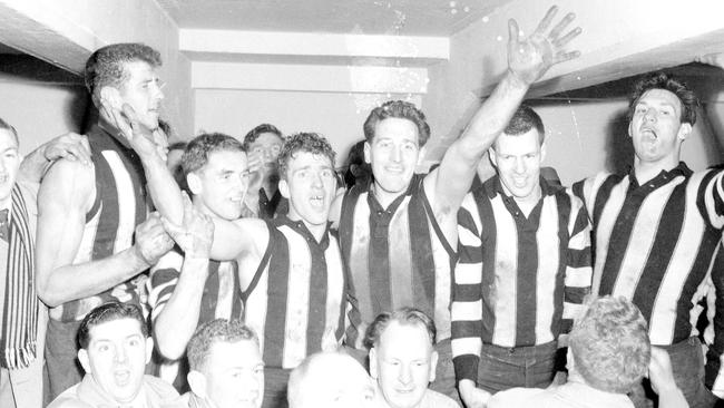 Murray Weideman (centre, right) celebrates the 1958 grand final victory with his Collingwood teammates.