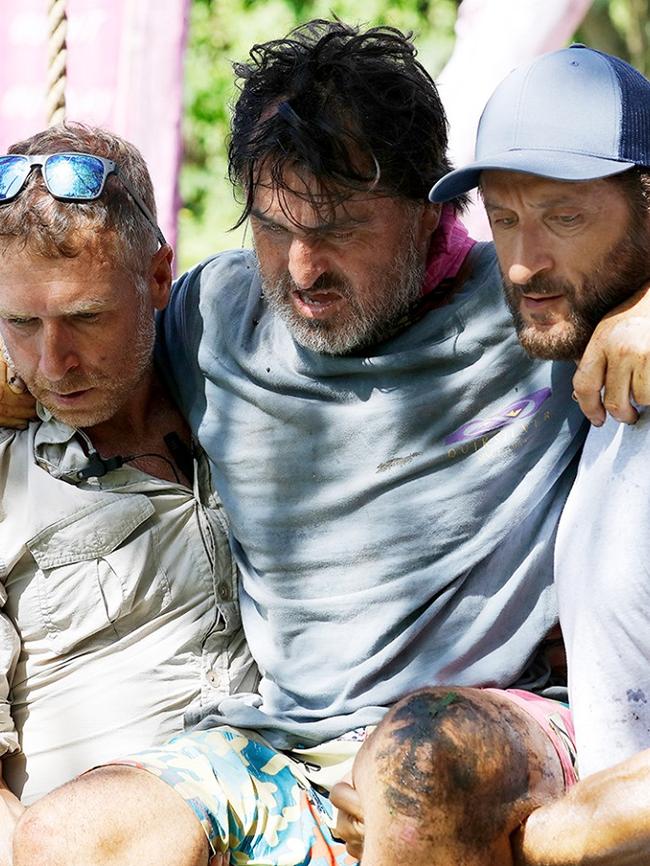 Ross Clarke-Jones is carried by Survivor host Jonathan LaPaglia and a medic after injuring himself during a challenge. Picture: Network 10