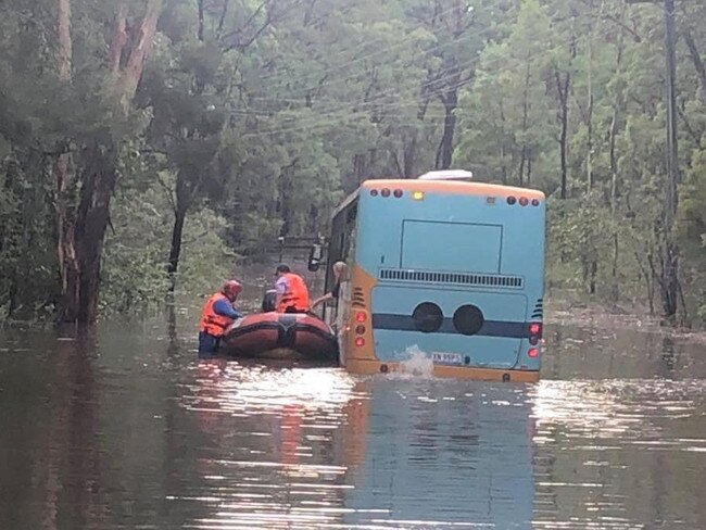 A Flood Rescue team from the NSW SES Hawkesbury Unit with Assistance from the RFS have attended Reedy Road at Maraylya where a bus driver and six children needed to be rescued after the bus became stuck in floodwater. Picture: NSW SES