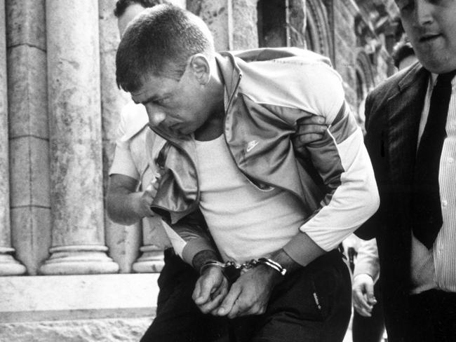 Victor Peirce is lead into the Magistrates’ Court by police.