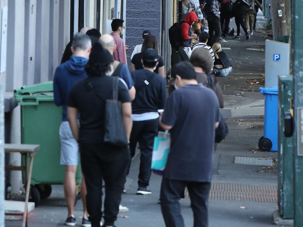 The line at Darlinghurst was even longer by 7.30am. Picture Rohan Kelly