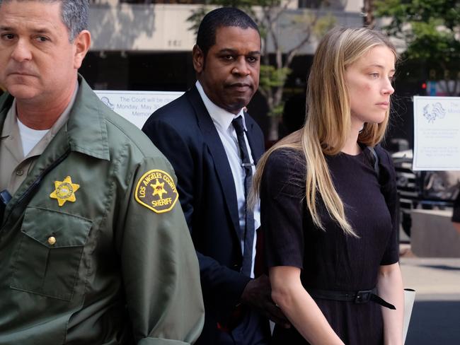 A clearly bruised Amber Heard cut a sombre figure in a Los Angeles court yesterday. Picture: AP/Richard Vogel