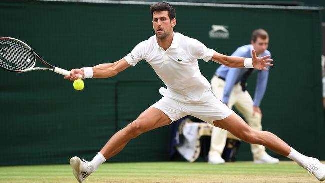 Novak Djokovic stretches for a ball in his semi-final match against Rafael Nadal.