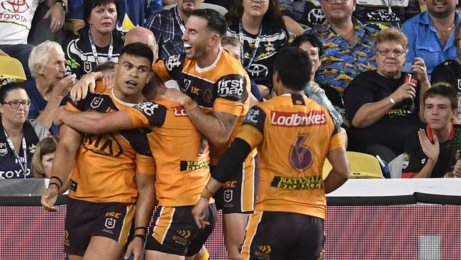 Broncos players embrace David Fifita after his stirring try. Picture: Ian Hitchcock/Getty Images