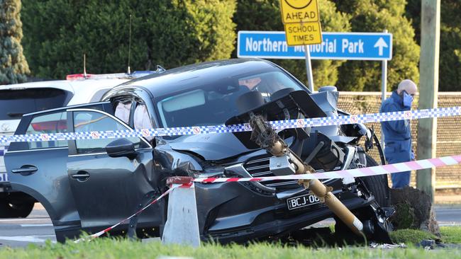 The gunmen’s car then crashed into fire hydrant. Picture: David Crosling