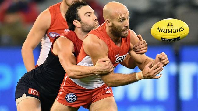 Jarrad McVeigh is tackled by Jordan Lewis.