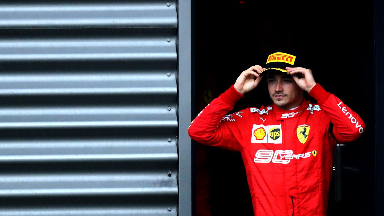 Race winner Charles Leclerc walks onto the podium at Spa.