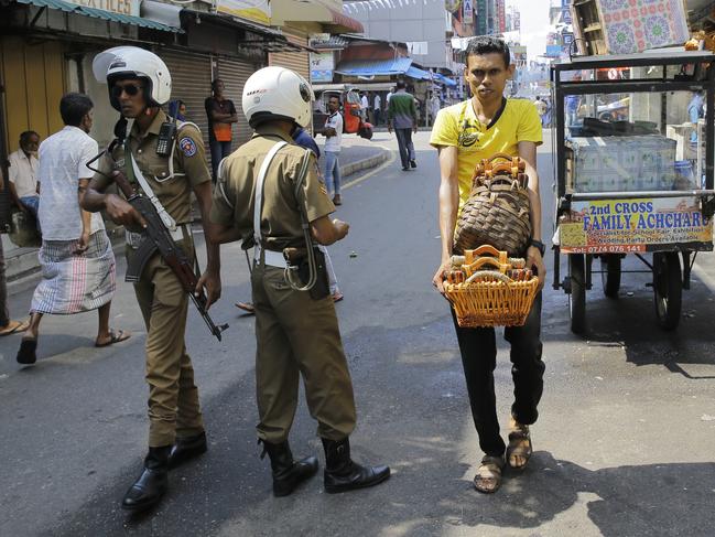 Sri Lankan police officers patrol in a street outside a mosque in Colombo. Picture: AP 