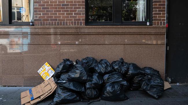 Dozens of rubbish bags were left on the sidewalk as they awaited collection. Picture: NCA NewsWire / Flavio Brancaleone