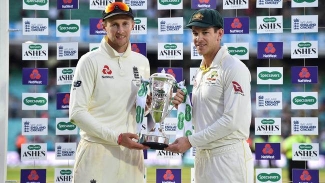 England's captain Joe Root (L) and Australia's captain Tim Paine hold the Ashes trophy during the presentation ceremony at The Oval in London.