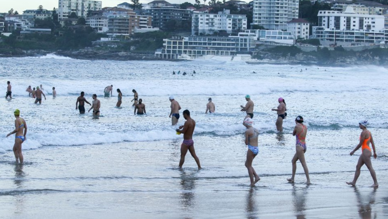 Crowds flock to Bondi Beach on Friday and brave the cold as lockdown restrictions ease. Picture: www.matrixnews.com.au