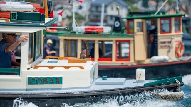 Work- and tugboats in formation on Sydney Harbour. Picture: Thomas Lisson