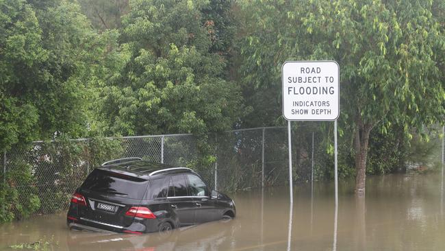 Flooding on the Gold coast in the aftermath of Cyclone Alfred. A Mercedes in a watery grave in Chisolm Rd.. Picture Glenn Hampson