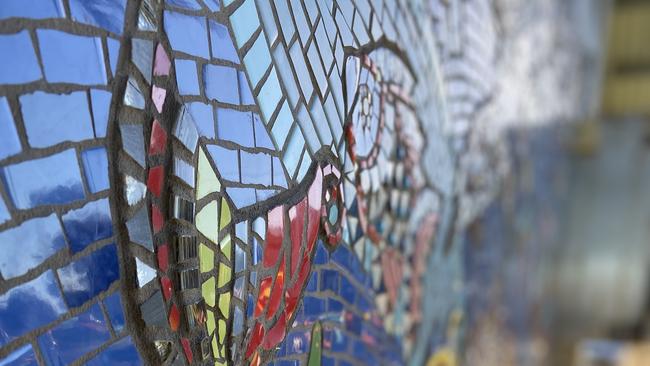 Two years in the making, 230 contributors from around the country, 100,000 pieces of tessera and an army of volunteers is what it took to bring Paul Perry's vision for the new artwork surrounding the public toilets at Archie's Beach.