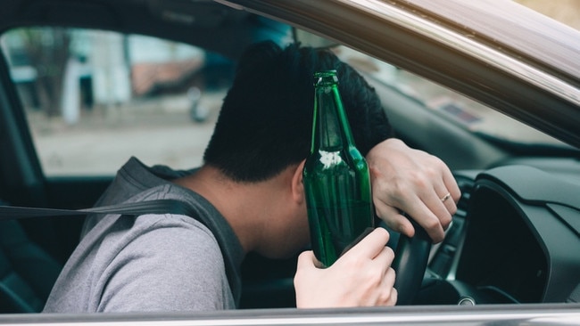 Asian men drink a lot of alcohol until and unconscious his can't drive home and decide to sleep at the steering wheel. Photo: iStock