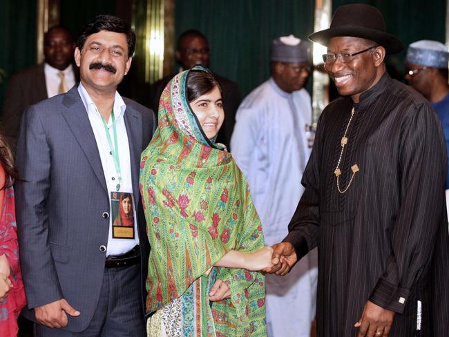 Pakistani education activist Malala Yousafzai shakes hands with Nigerian President Goodluck Jonathan (R) next to her father, Ziauddin Yousafzai ( L). Picture: Wole Emmanuel