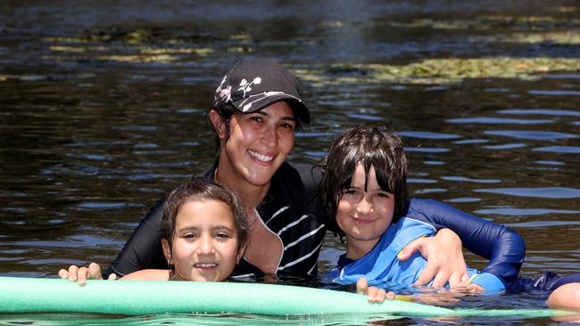 Nora Darwish cools off with her children Zarah, 6, and Jacob, 7, at Lake Parramatta. Picture: Damian Shaw