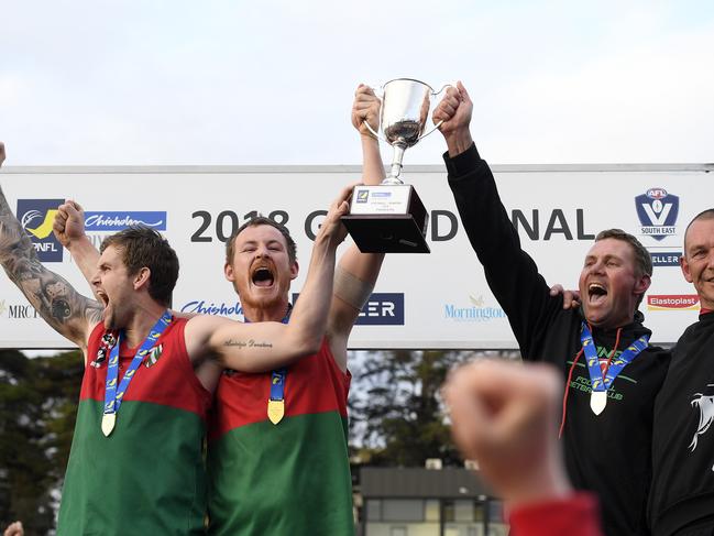 Paddy Swayn and co-captains Tim Bongetti and Beau Hendry lift the premiership cup after Pines won the 2018 MPNFL Division 1 grand final. Picture: Andy Brownbill