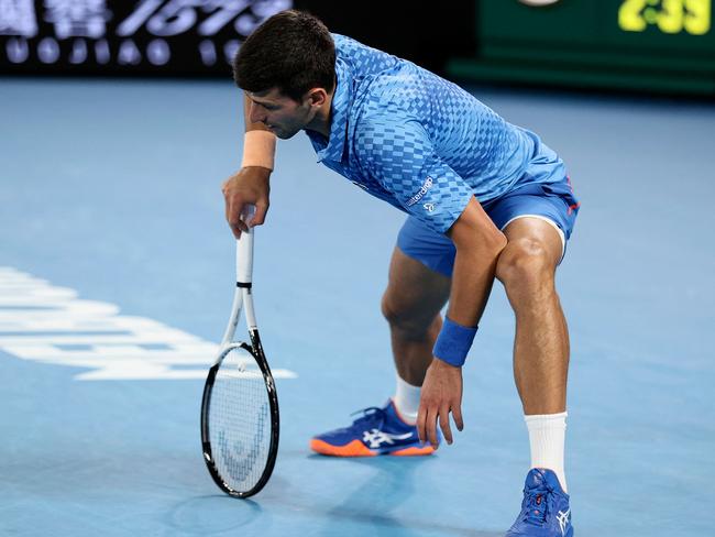 Serbia's Novak Djokovic reacts as he competes against Bulgaria's Grigor Dimitrov during their men's singles match on day six of the Australian Open tennis tournament in Melbourne on January 21, 2023. (Photo by Martin KEEP / AFP) / -- IMAGE RESTRICTED TO EDITORIAL USE - STRICTLY NO COMMERCIAL USE --