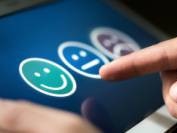 Survey, poll or questionnaire for user experience or customer satisfaction research. Quality control and feedback concept. Man choosing his opinion with smiley faces on touch screen.