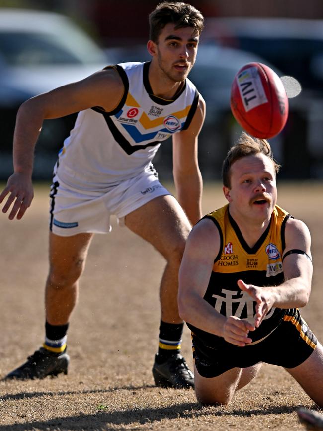 Werribee Districts’ Jordan Patty gets a handball away. Picture: Andy Brownbill