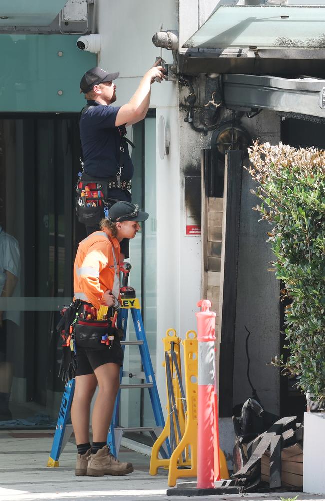 Workmen assessing the damage to the Black Lamb the morning of the arson attack. Picture: Glenn Hampson