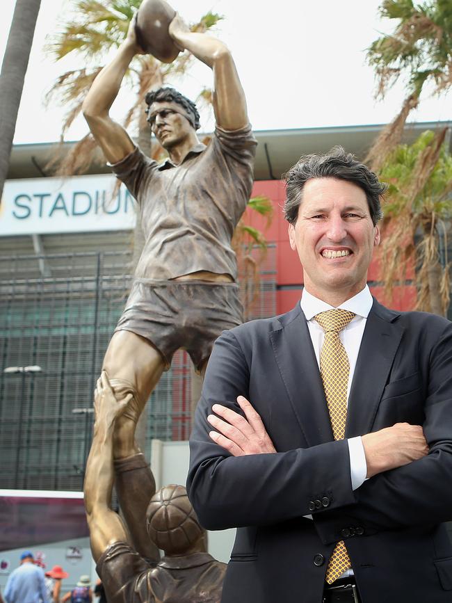 Rugby great John Eales with his statue outside the stadium. (AAP Image/Jono Searle) N