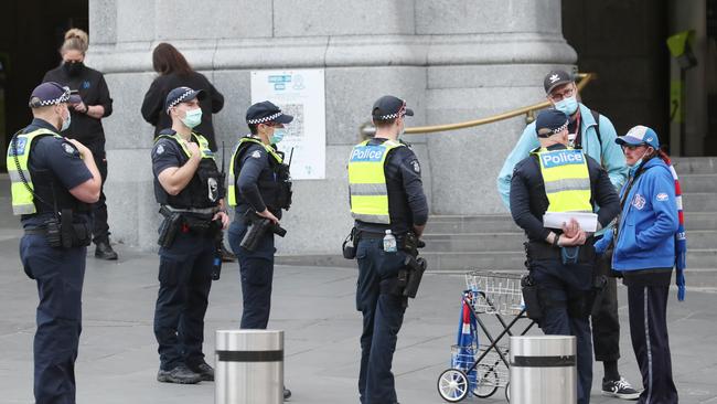 Police swarm CBD streets in readiness for the protest. Picture: David Crosling