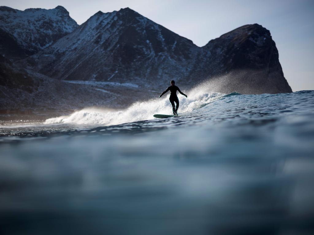 A surfer rides a wave, on March 10, 2018, in Unstad, northern Norway, Lofoten islands, within the Arctic Circle. Picture: AFP