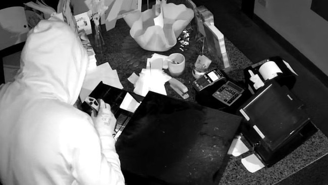 A suspect rummages through a cash register inside Emerson’s Restaurant at Lovedale about 6am on March 8. Picture: supplied