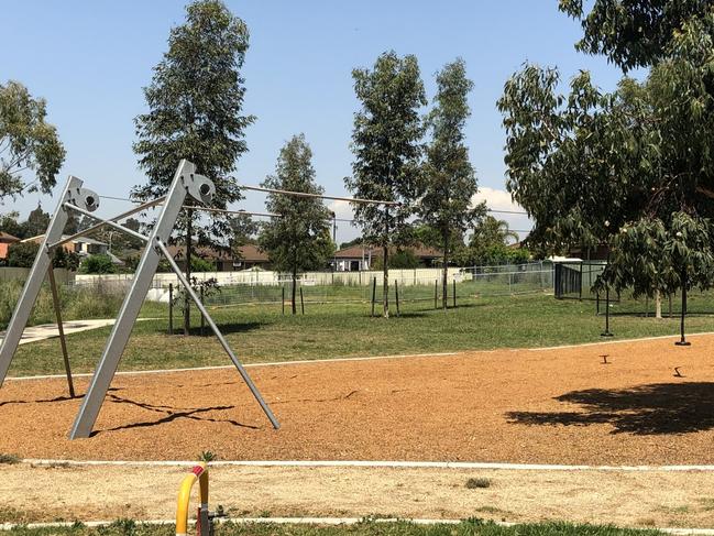 Play equipment in the foreground, with the fenced off asbestos site in the background. Picture: Tony Ibrahim