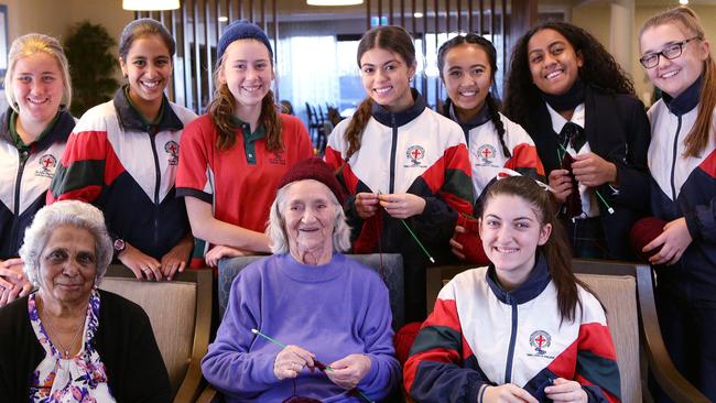 Students from St John Paul II and residents of Quakers Hill Nursing Home knitting beanies for Australian troops. Pictures: Carmela Roche